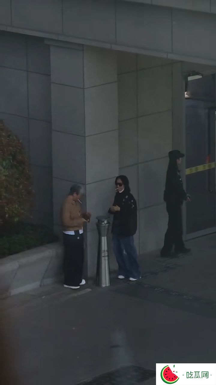 惠英红同一地方再次抽烟，身旁多了一位打扮中性的女士。